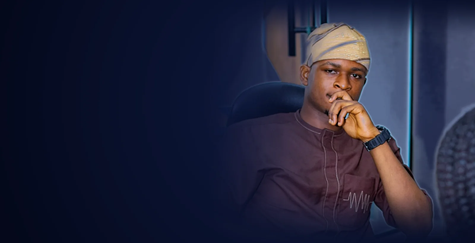 Ayodele Daniel T., AI engineer and brand strategist, seated in thought in Lagos